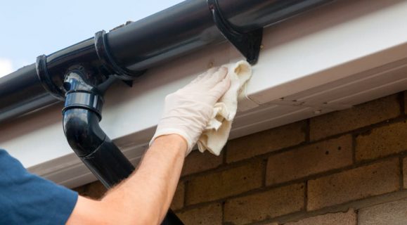 Roof gutter getting cleaned — Gutter Systems in Sydney, NSW